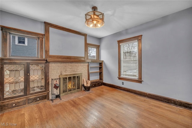 unfurnished living room featuring hardwood / wood-style flooring and a fireplace