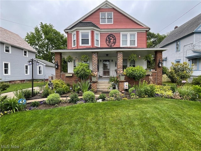 view of front of home featuring a front yard and a porch