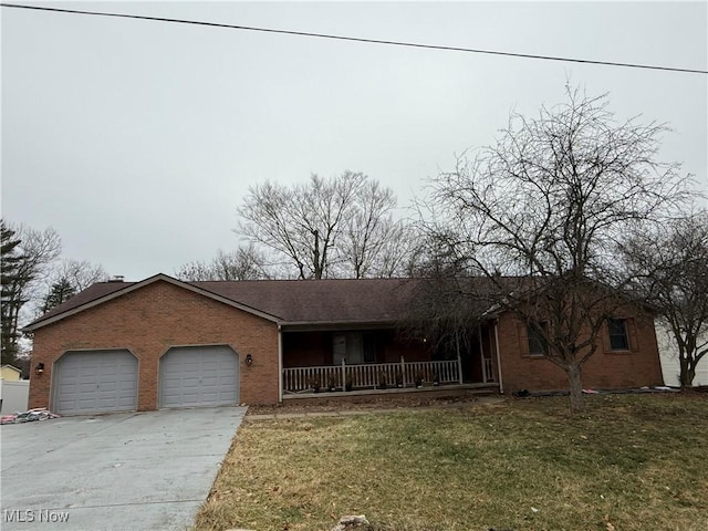 ranch-style home with a garage, a front lawn, and a porch