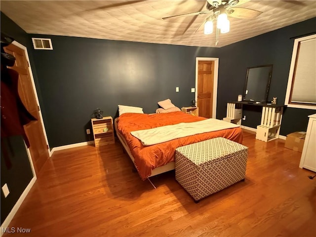 bedroom featuring ceiling fan and hardwood / wood-style floors