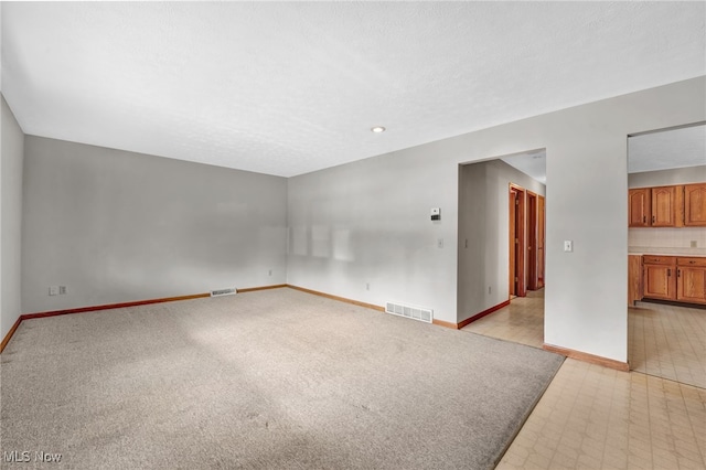 unfurnished room featuring a textured ceiling