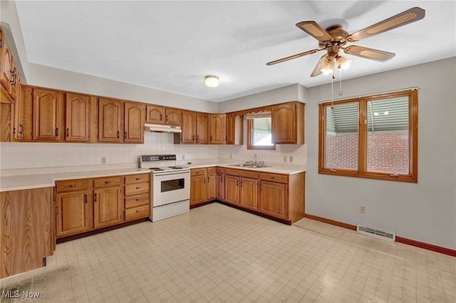 kitchen featuring tasteful backsplash, sink, white electric range oven, and ceiling fan