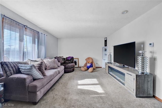 living room featuring light carpet and a textured ceiling