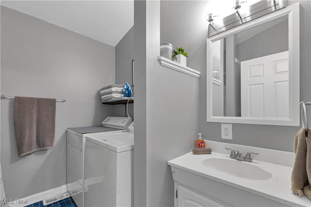 bathroom featuring vanity and separate washer and dryer