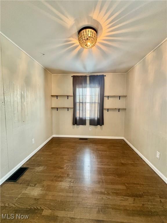 spare room featuring dark hardwood / wood-style floors