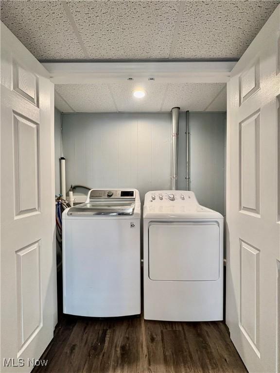 clothes washing area featuring separate washer and dryer and dark hardwood / wood-style floors