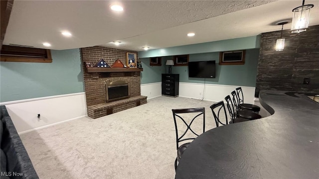 carpeted living room with a fireplace and a textured ceiling