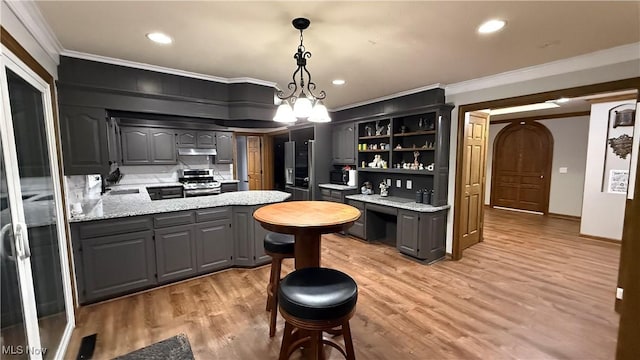 kitchen with gray cabinets, decorative light fixtures, light hardwood / wood-style floors, crown molding, and stainless steel range oven