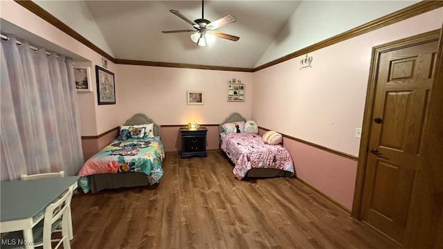 bedroom featuring dark wood-type flooring, ceiling fan, ornamental molding, and vaulted ceiling