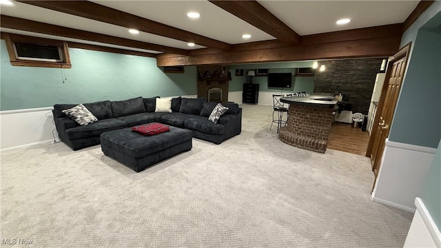 living room with light colored carpet, beamed ceiling, and indoor bar