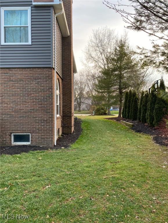 view of home's exterior with a lawn