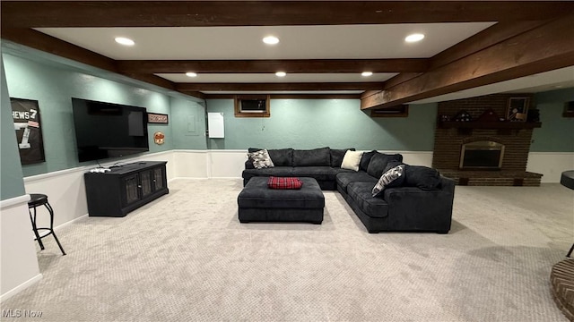 living room featuring beamed ceiling, a brick fireplace, and light colored carpet