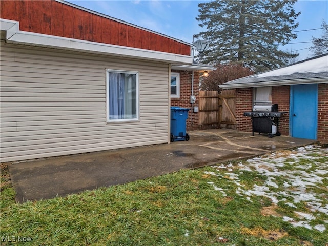 view of side of home with a patio area