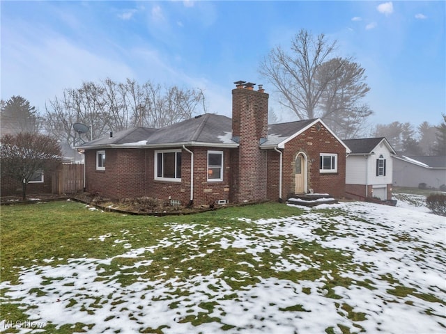 snow covered property featuring a lawn