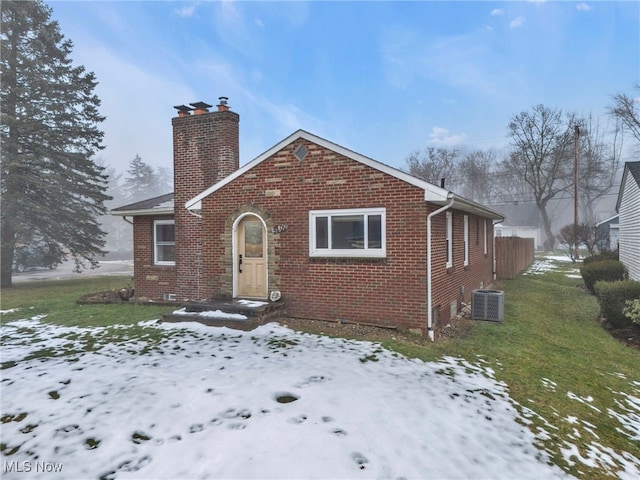 view of front of property with a yard and cooling unit