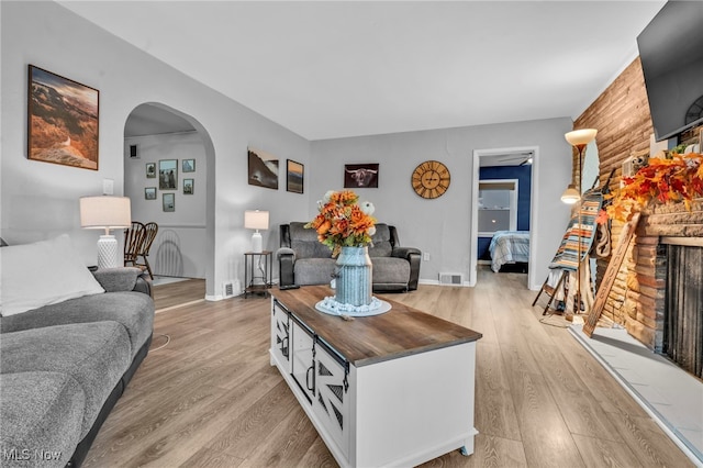 living room with a fireplace and light hardwood / wood-style floors