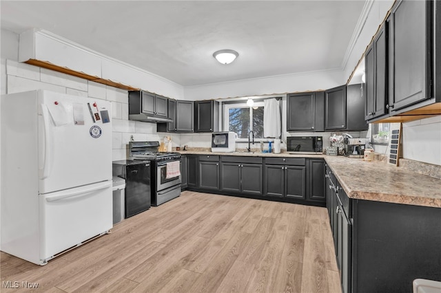 kitchen featuring gas range, ornamental molding, light hardwood / wood-style floors, and white fridge