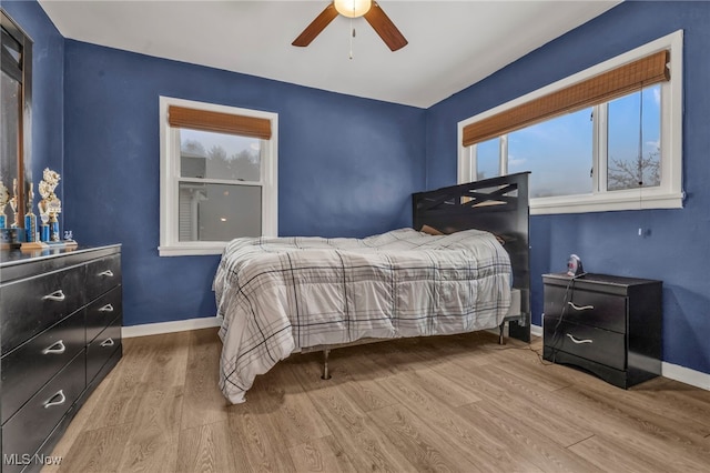 bedroom with ceiling fan and light wood-type flooring