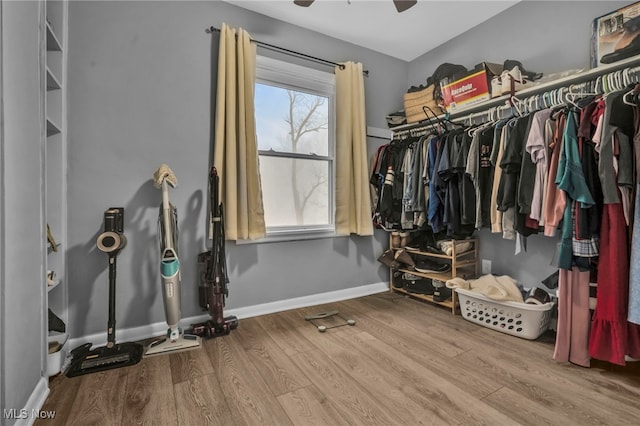 spacious closet with light hardwood / wood-style flooring and ceiling fan