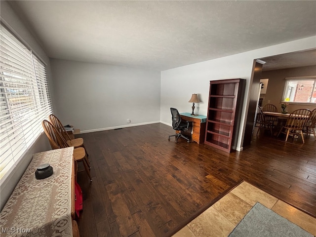 office space with dark hardwood / wood-style flooring and a textured ceiling