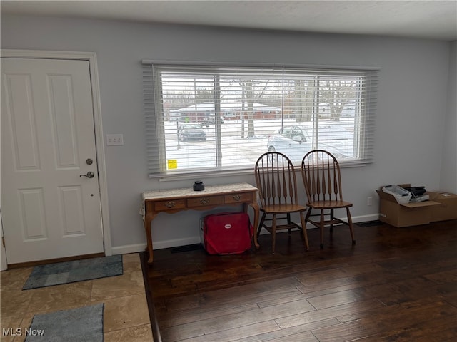 dining room featuring a healthy amount of sunlight and dark hardwood / wood-style flooring