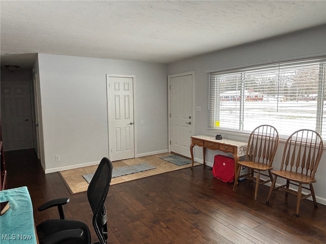 office space featuring a textured ceiling and dark hardwood / wood-style flooring