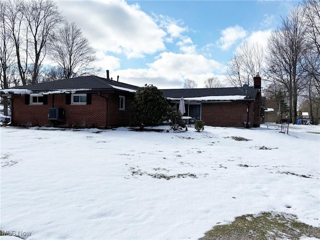 view of snow covered rear of property