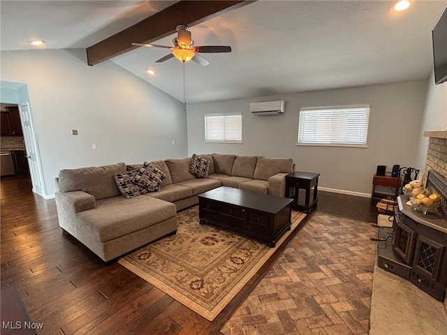 living room featuring dark hardwood / wood-style floors, lofted ceiling with beams, a wall mounted AC, ceiling fan, and a brick fireplace