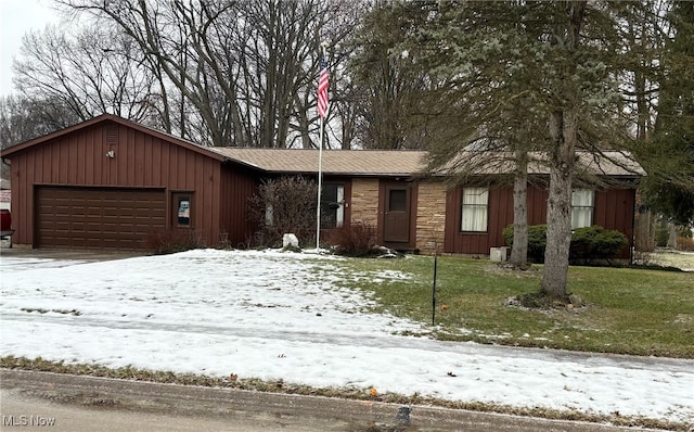 ranch-style house with a garage and a yard