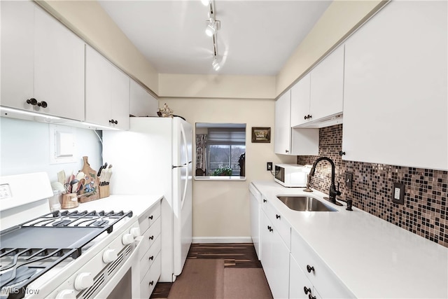 kitchen featuring sink, white appliances, backsplash, white cabinets, and dark hardwood / wood-style flooring