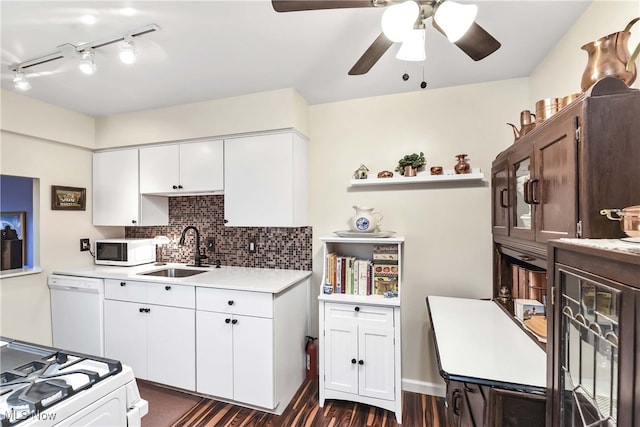 kitchen featuring white cabinetry, sink, backsplash, and white appliances