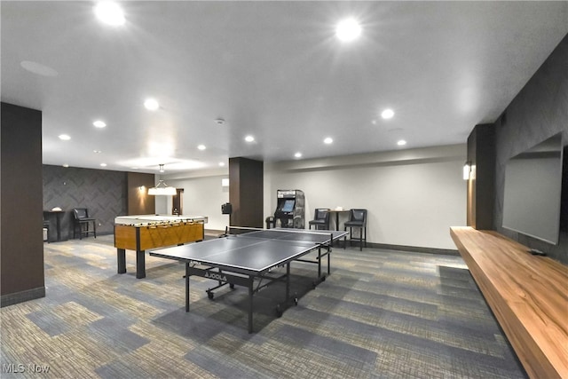 recreation room with dark carpet