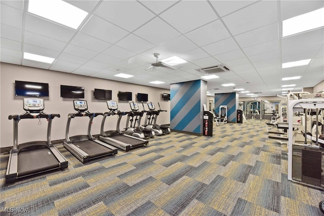 exercise room featuring carpet floors and a drop ceiling