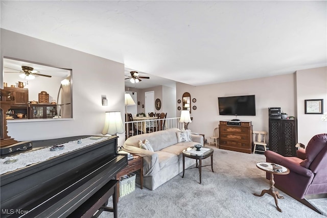 carpeted living room featuring ceiling fan