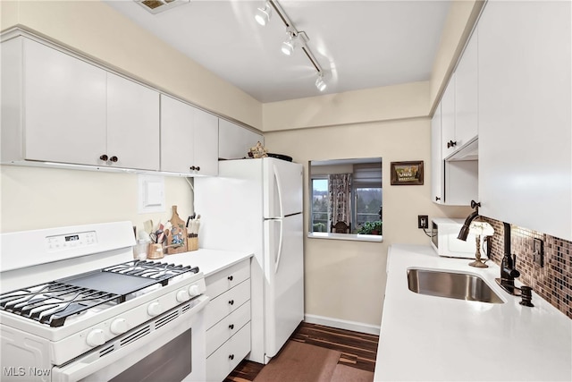 kitchen featuring dark hardwood / wood-style flooring, sink, white appliances, and white cabinets