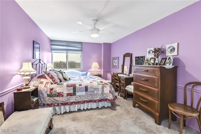 bedroom featuring light carpet and ceiling fan