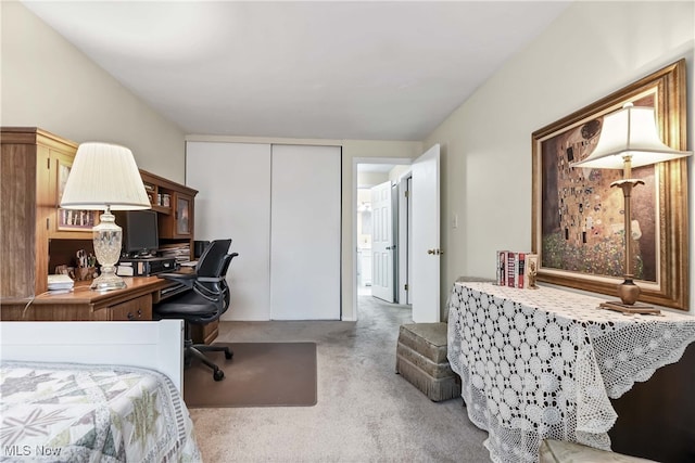 bedroom featuring a closet and light carpet