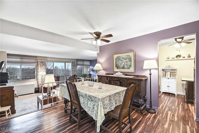 dining space with dark wood-type flooring and ceiling fan