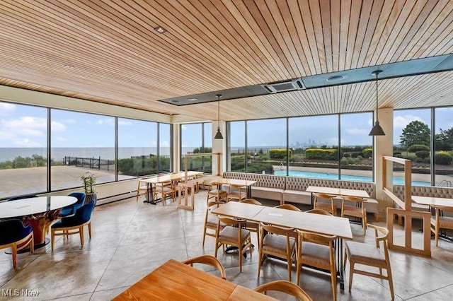 sunroom / solarium featuring a water view, a wealth of natural light, and wooden ceiling