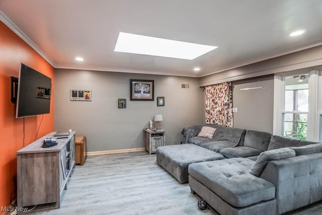 living room featuring hardwood / wood-style floors, a skylight, and ornamental molding