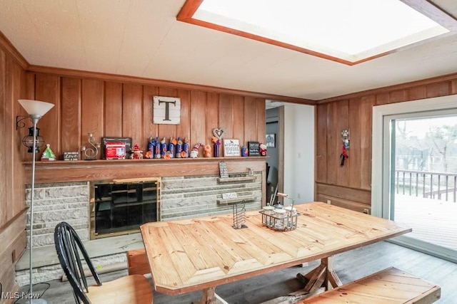 kitchen with light hardwood / wood-style flooring and wooden walls