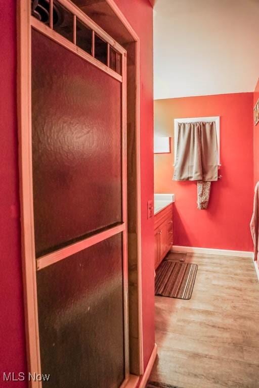 bathroom with vanity and hardwood / wood-style flooring