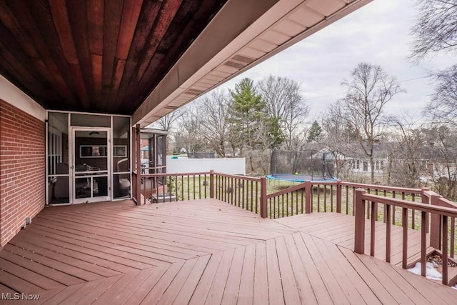 wooden deck with a trampoline