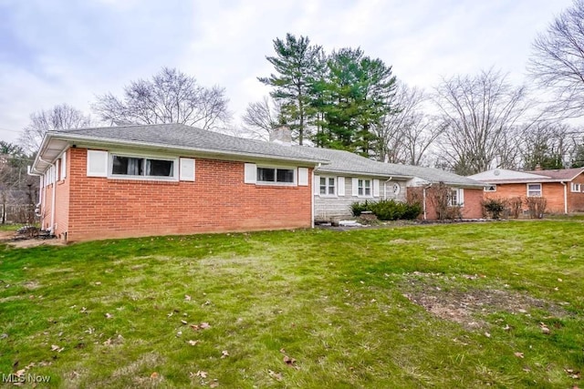 rear view of property featuring a yard