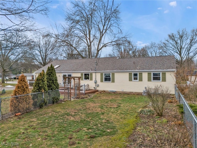 back of property featuring a yard and a deck