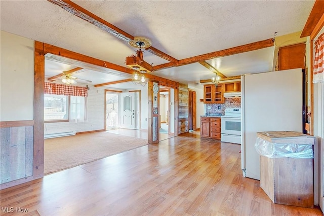 kitchen featuring beam ceiling, a textured ceiling, white appliances, and light hardwood / wood-style floors