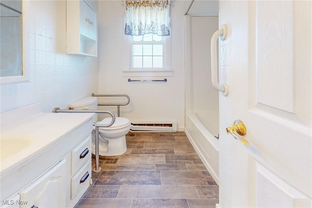 bathroom featuring a baseboard radiator, vanity, toilet, and tile walls