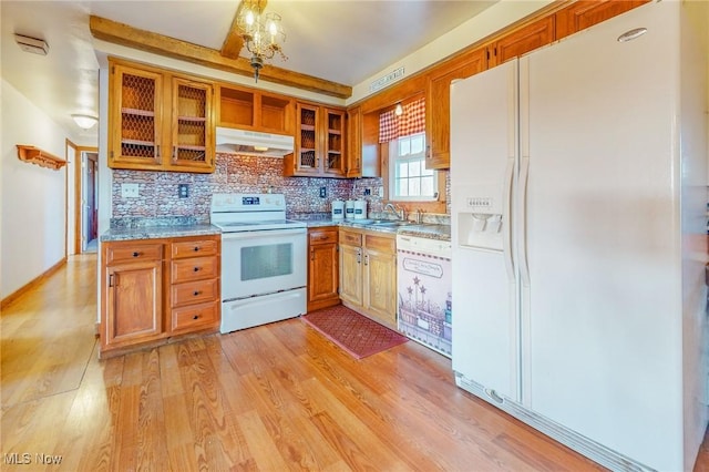 kitchen with light wood-type flooring, sink, white appliances, and decorative backsplash