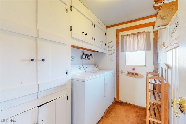 laundry room with cabinets, light colored carpet, and washer and clothes dryer