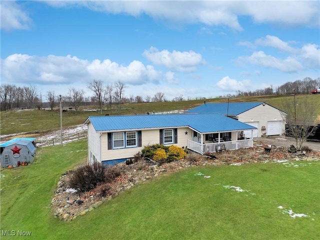 view of front of home with a garage, a front lawn, and covered porch